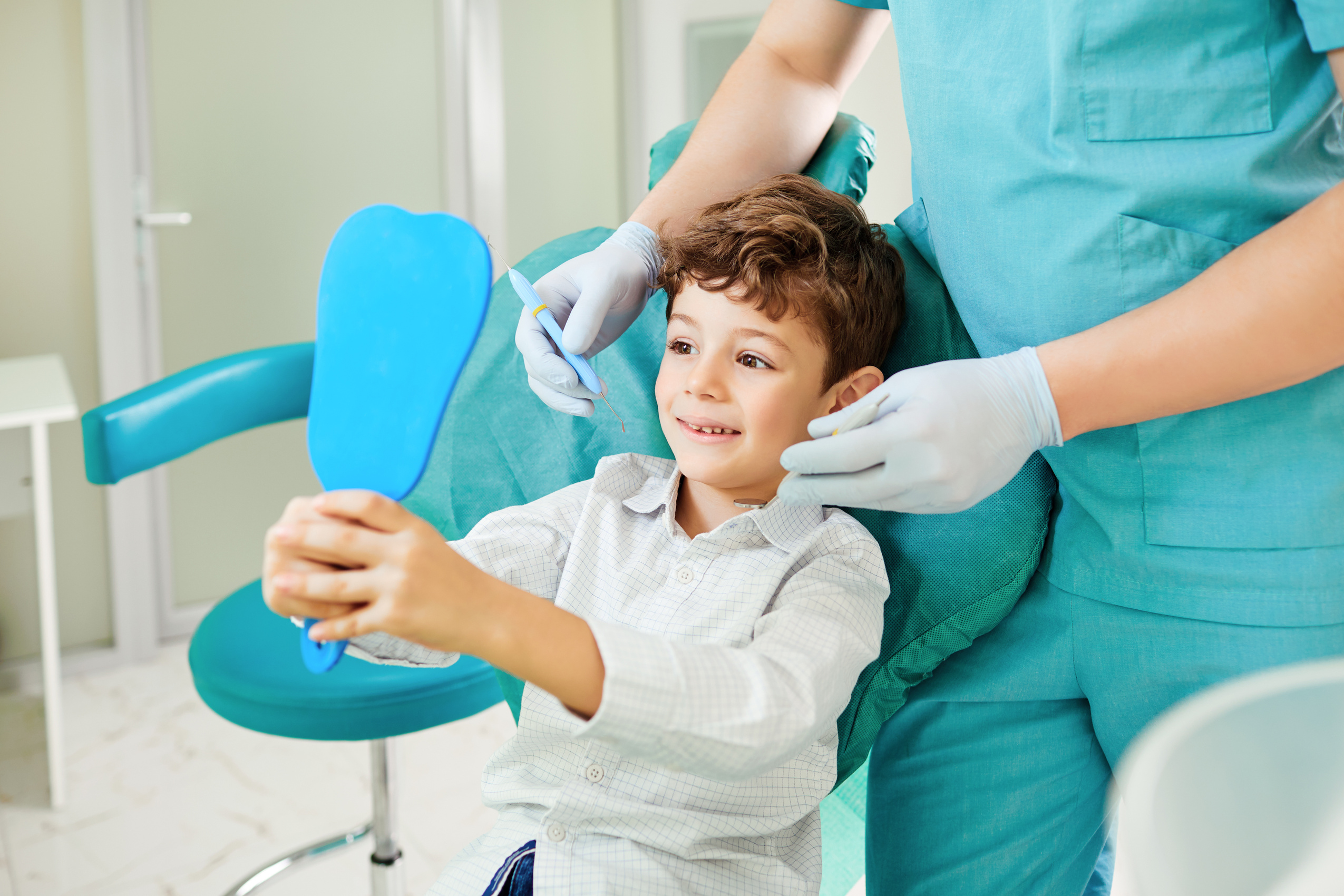 Boy Child and Dentist Are Checking Teeth in the Mirror.